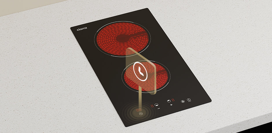 ceramic cooktop with two red heating elements on a white surface