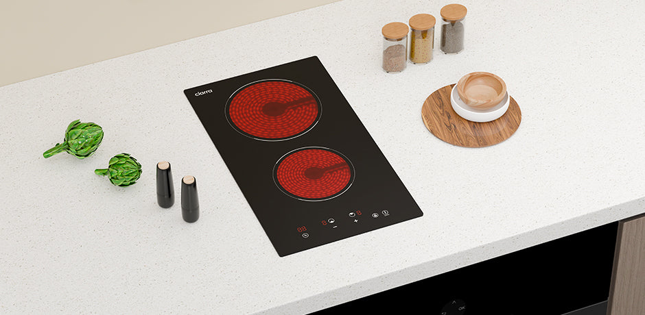 Induction cooktop on a white countertop with kitchen items around