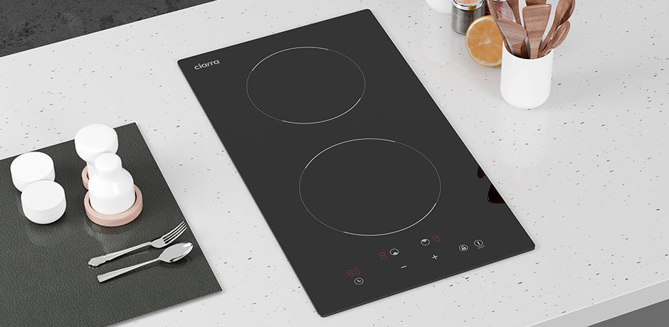 Ceramic cooktop on a kitchen counter with utensils and containers.