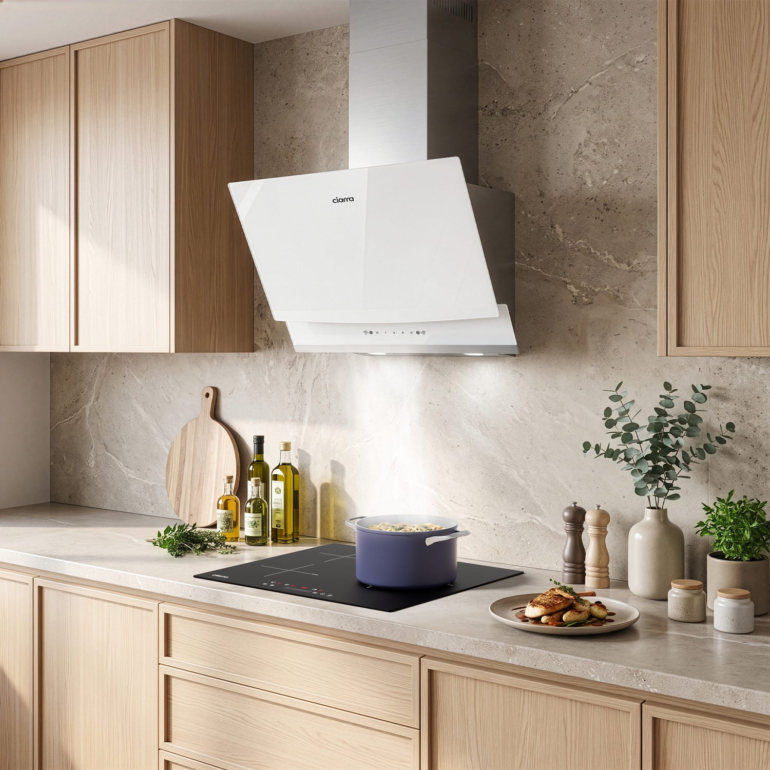 A white CIARRA cooker hood mounted on a light stone backsplash above a black induction cooktop in a modern kitchen with light wood cabinets and countertop decor.