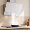 White 60cm angled wall-mounted CIARRA CBCW6736A cooker hood, featuring angled cooker hood design, 710 m³/h extraction rate, ducted & recirculating ventilation modes, used for fume extraction during high-heat home kitchen stir-frying