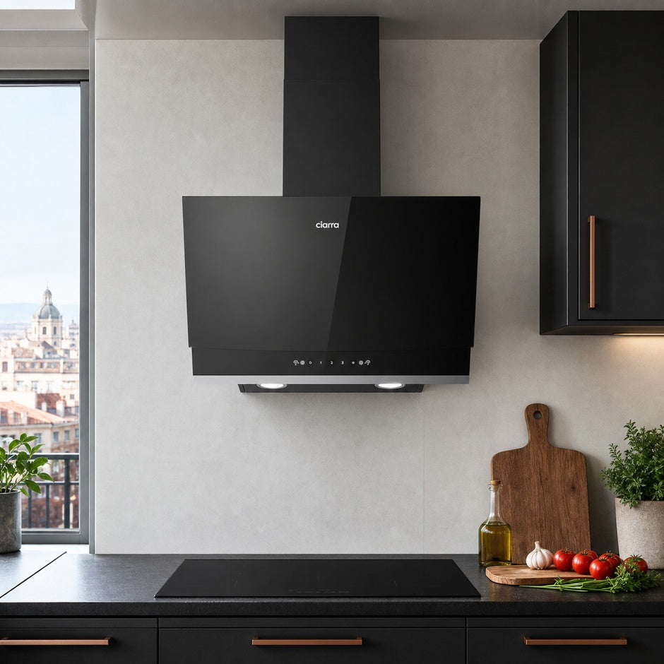 A black CIARRA cooker hood mounted on a light grey textured wall in a modern kitchen setting with dark cabinets, a window view, and kitchen props on the counter.